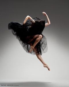 dancer in black dramatic jump