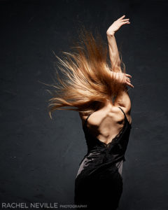 Backside movement shot of dancer Charlotte Landreau with blonde hair blowing in wind by Rachel Neville Photography