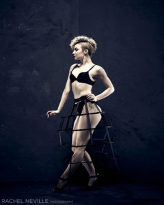Photo of dancer Paloma Garcia-Lee in a black bra and cage skirt by Photographer Rachel Neville