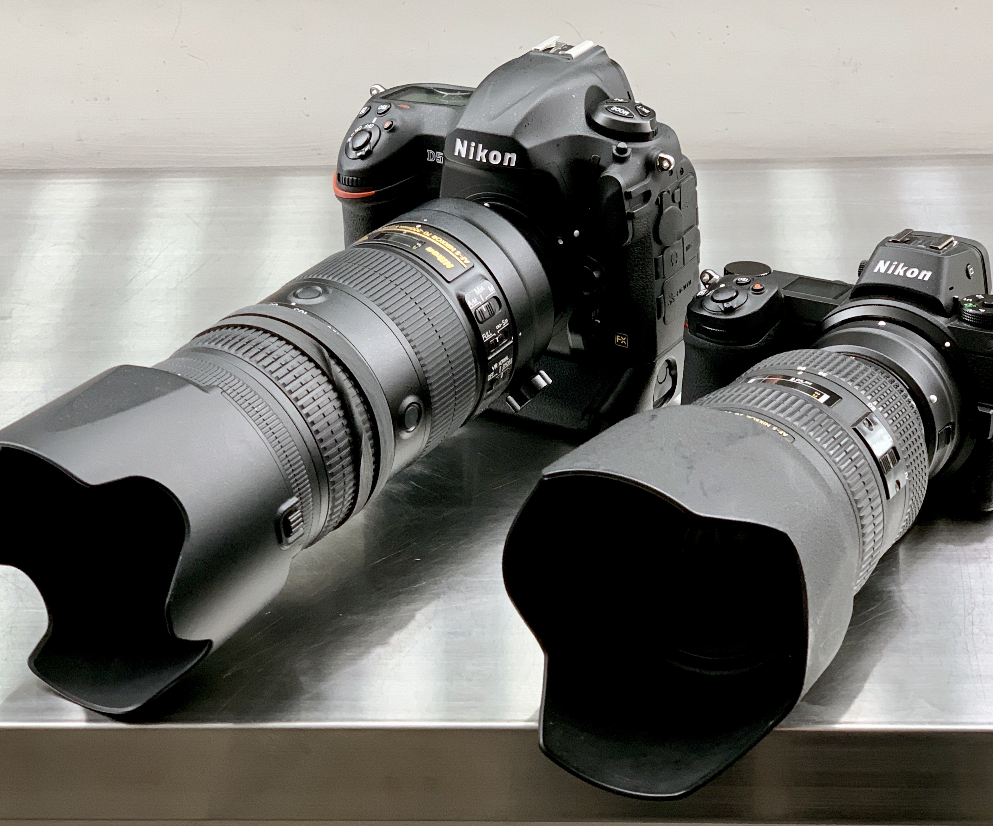 Picture of both nikon D5 and z6 cameras on silver counter